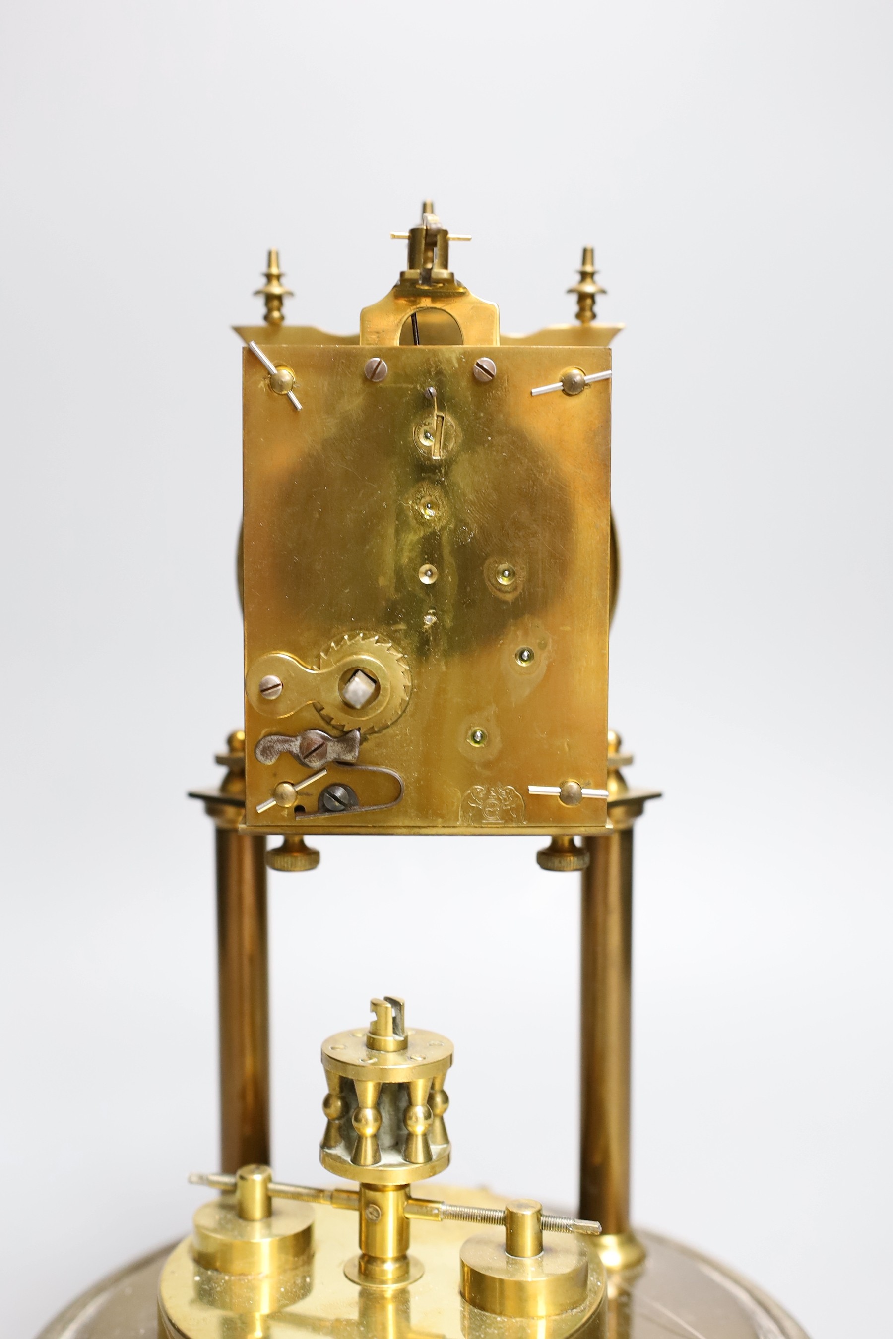 A German 400 day brass mantel timepiece, under a glass dome, 30cm total